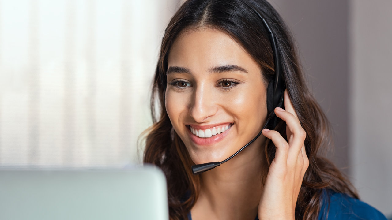 smiling woman while in virtual meeting
