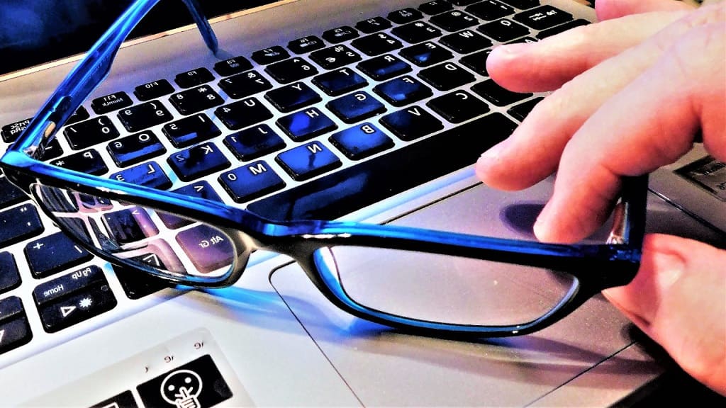glasses on laptop keyboard